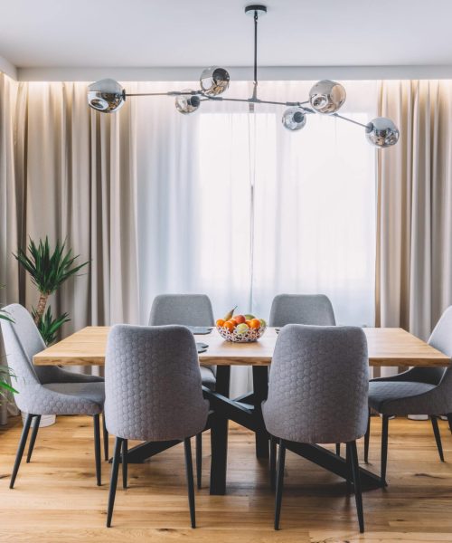 Dining,Room,With,Wooden,Table,And,Floor,In,Modern,Apartment.